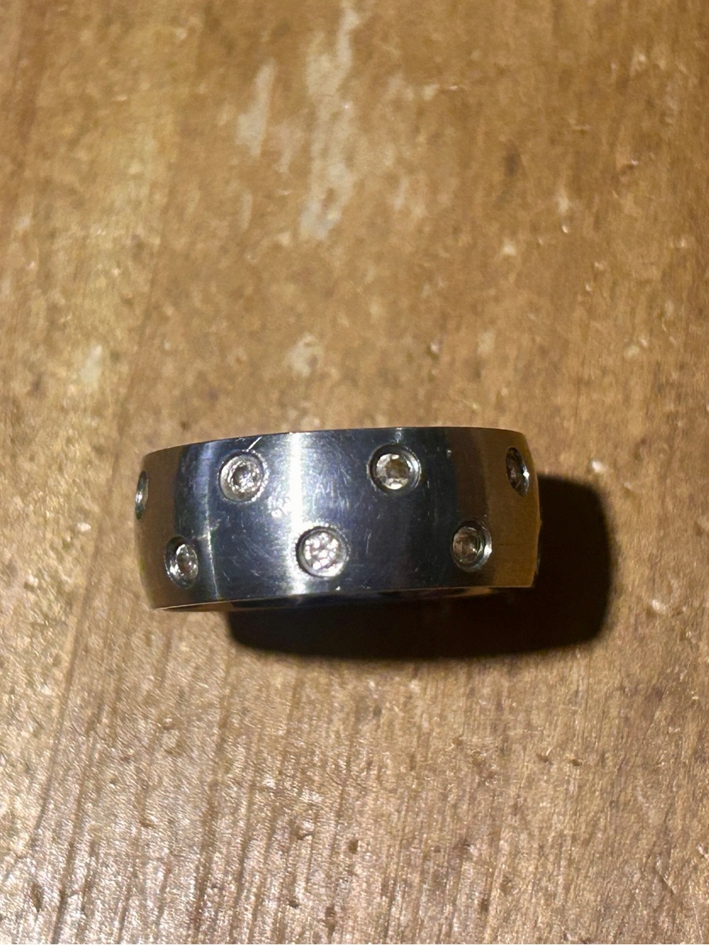 Polished stainless steel Band Ring with embedded cubic zirconicas